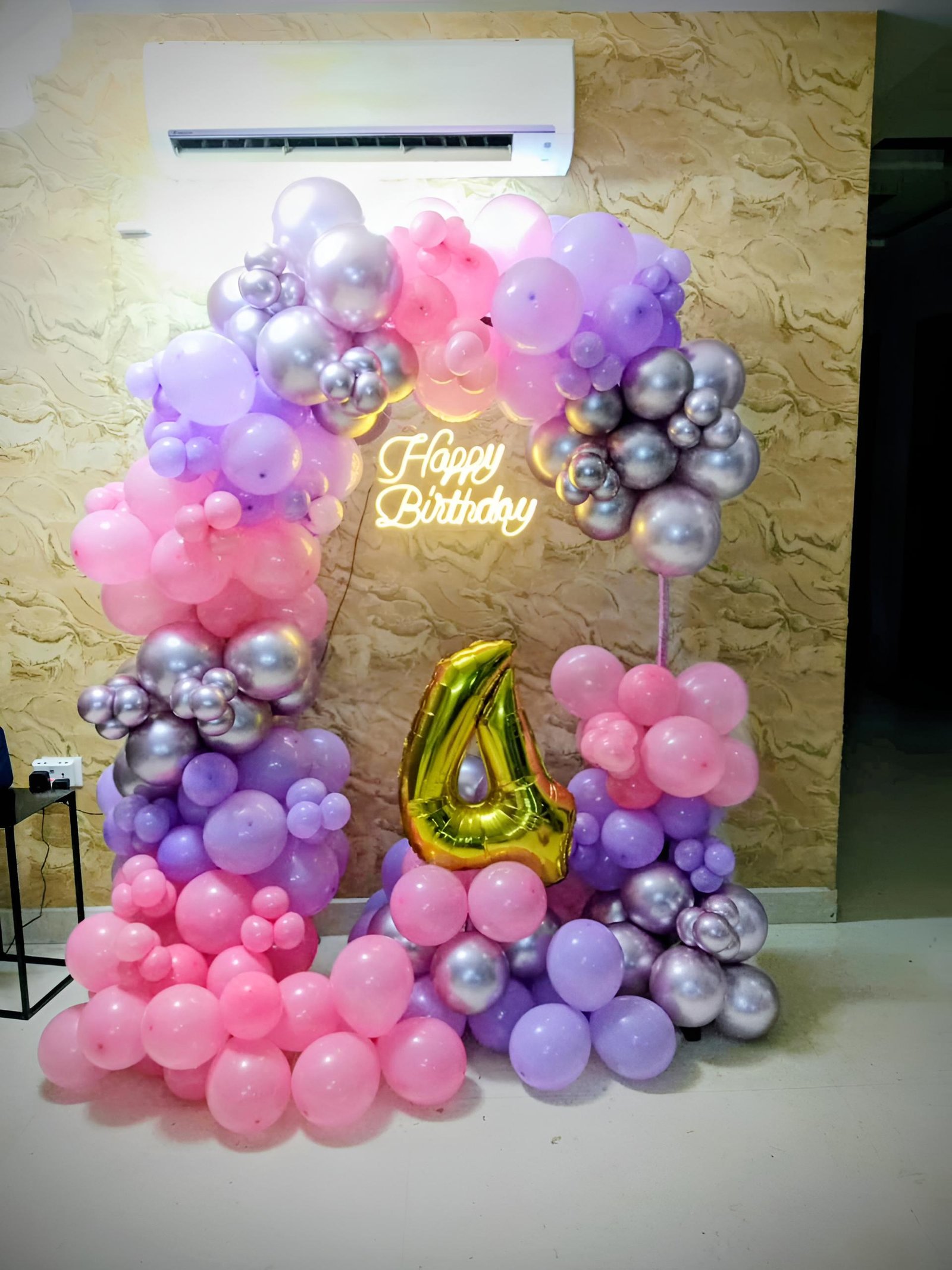 Make your little girl’s special day memorable with this beautiful Pink, Purple & Silver Girl Birthday Decoration. The setup features a stylish balloon arch, customized 4th birthday number and Happy Birthday Neon Light, perfect for a Girl’s 4th Birthday Party at home or any celebration venue.Beautiful girl birthday party decoration with pink, purple and silver balloon decoration, 4th birthday decoration for girl, birthday balloon arch, customized age number and Happy Birthday neon light. Perfect for 4th birthday party decoration at home, kids birthday decoration, baby girl birthday decoration and birthday celebration in Delhi NCR.