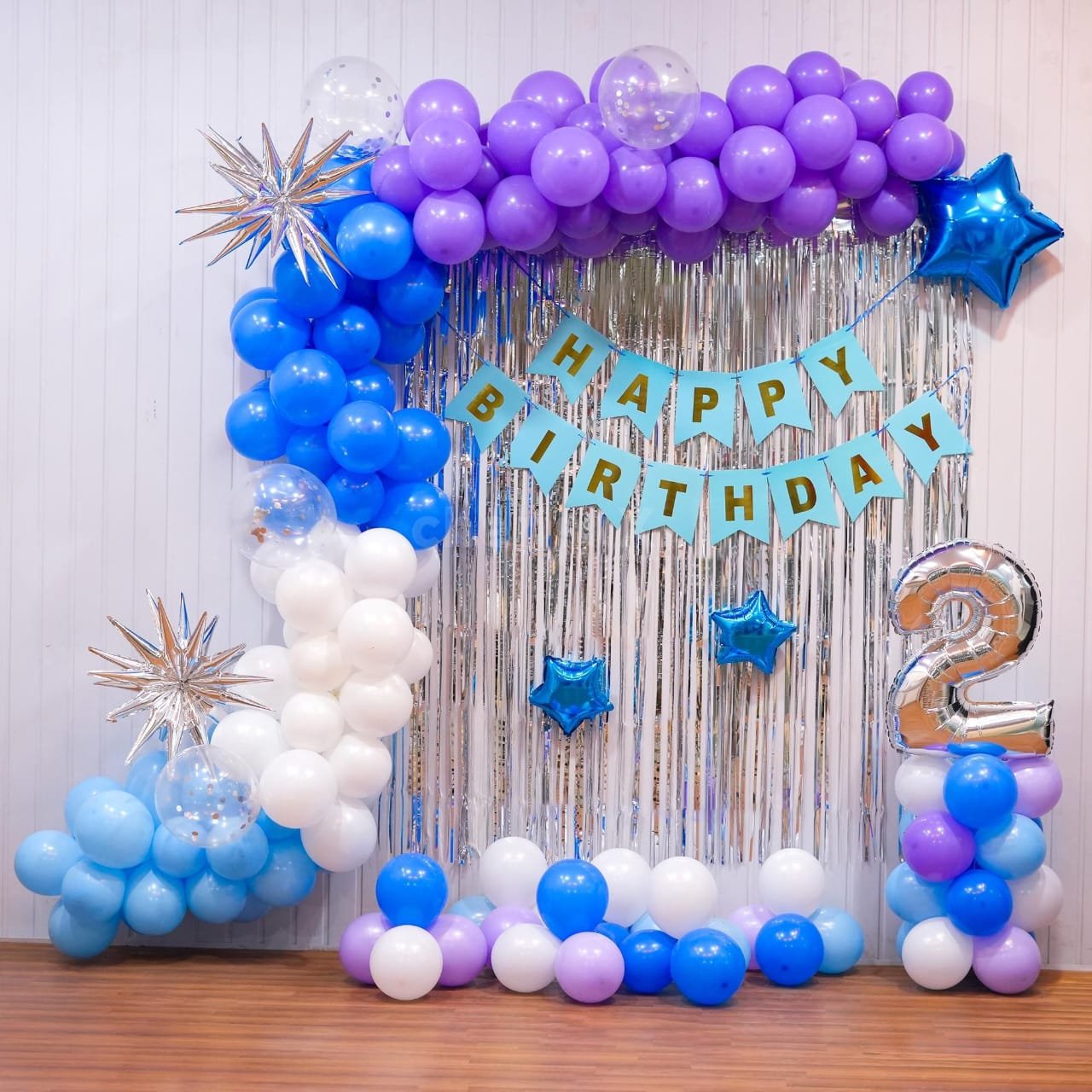 Celebrate your special day with our Blue & Purple Birthday Decoration, featuring a beautiful balloon garland, silver shimmer backdrop, star balloons, Happy Birthday banner and customizable age number. This elegant balloon decoration is perfect for kids' birthdays, teen birthdays and home birthday parties.Birthday Decoration Service Available in Delhi NCR 📞 Book your Birthday Balloon Decoration in Delhi for a beautiful and memorable celebration.